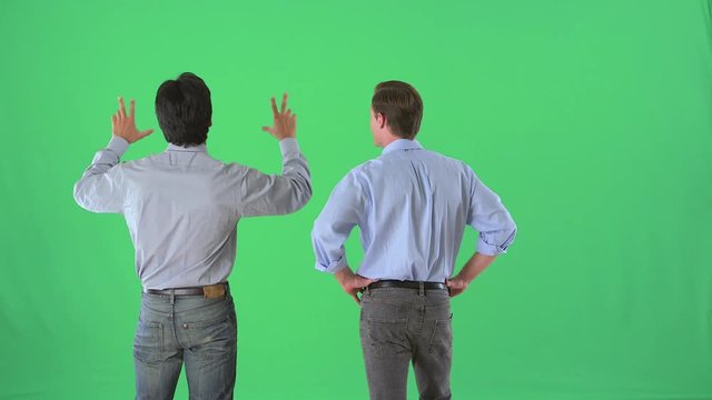 Businessmen talking in business casual attire on greenscreen
