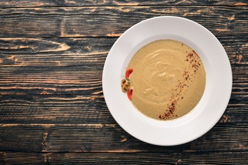 Mushroom puree soup. On a wooden background. Free space for your text. Top view.