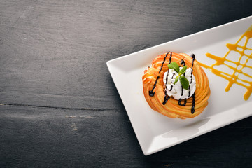 Cream Cake with Cream. On a wooden background. Free space for your text. Top view.