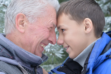 senior man and boy standing outdoors 