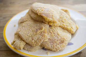 preparing breaded chicken breast