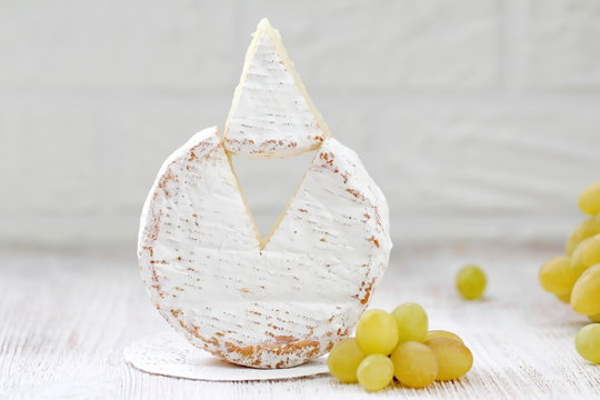 Brie type of cheese and grape. Camembert cheese.