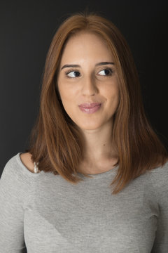 Portrait of a red hair young girl on black background