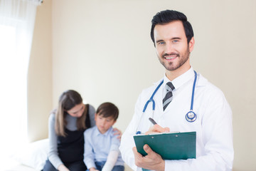 Fototapeta premium Doctor looking to camera with attractive smiling and patient background. People with medical concept.