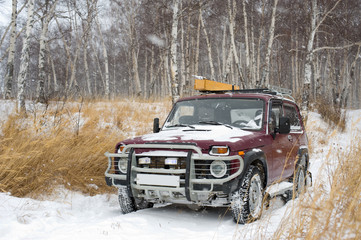 off-road vehicle in winter forest