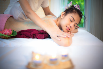 Obraz na płótnie Canvas Masseur doing massage spa with treatment sugar scrub on Asian woman body in the Thai spa lifestyle, so relax and luxury. Healthy Concept.