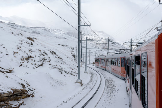 Red Train Of Gornergrat Bahn With Snow Around