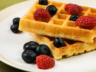 Fototapeta na wymiar Waffles With Fresh Raspberries and Blueberries