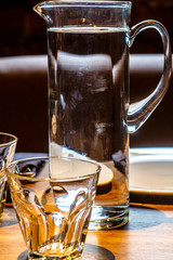 A carafe of water and glasses are on the table