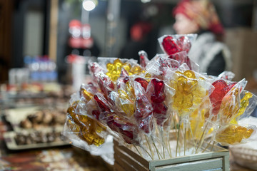 Stall with colorful and festive candies at the Christmas market, selective focus