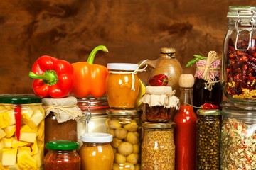 Ingredients for cooking on a wooden table. Glass of cooked vegetables and jam. Chef's workplace.