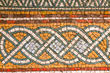 Fragment of ancient mosaic on the wall