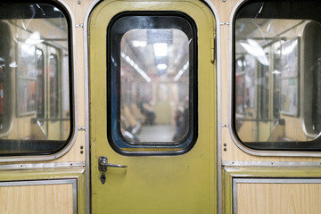 Old metro car, the door of the transition between the subway cars, underground public transport