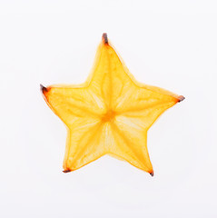 Fototapeta premium Yellow star fruit slice backlit, isolated on white
