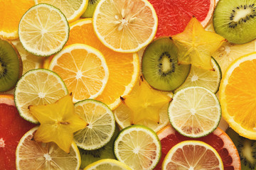 Fototapeta na wymiar Exotic fruits slices background