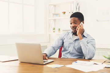 Young black businessman talking on mobile phone