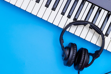 Music keyboard and Music headphone on blue copy space