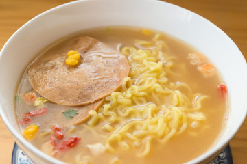 instant noodles with sauce and luncheon meat close up