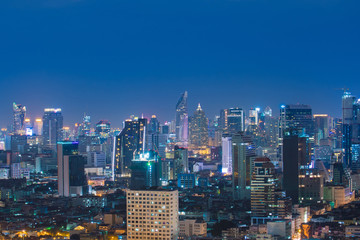 Bangkok city skyline, downtown, business district, hotel, residential building and office building at night.