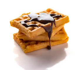 waffles with liquefied chocolate on a white background