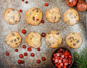 Cranberry (cowberry, lingonberry) cookies with white chocolate and powdered sugar. Homemade treats for Christmas and new year. Selective focus. Top view