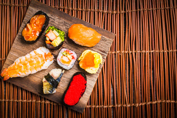 Sushi Set sashimi and sushi rolls served on wood slate.Copy space for your text.,Top view