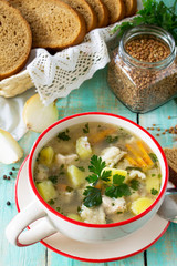 Homemade soup with buckwheat and pasta (dumplings) on the kitchen table.