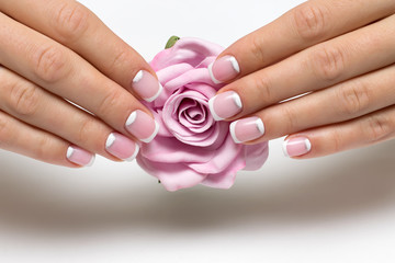 wedding French manicure with silver on short square nails with a pink rose in hands

