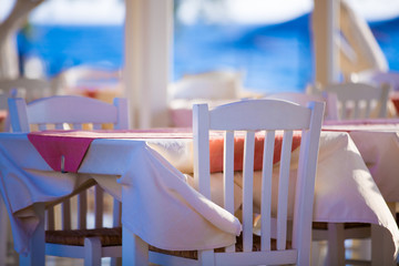 Outdoor cafes in coastline resort Kamari in Santorini Greece