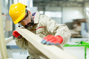 Middle aged worker working in the furniture factory