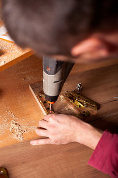 Carpenter work on wood plank in workshop