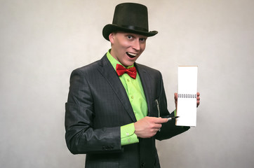 Secret detective agent in suit and hat holds in hand secret compromising evidence letter isolated on white. Secret service. A policeman writes down the testimony.