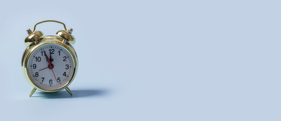 Golden clock on a blue background