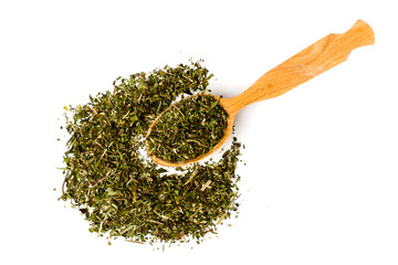 Green tea in wooden spoon and scattered on white background, isolated.