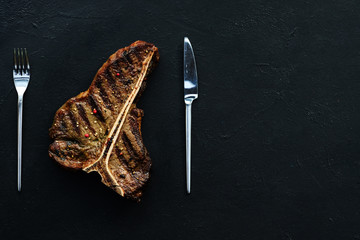 T bone steak on dark background. Grilled mexican style meat. Juicy tender pork chop. Simple tasty...