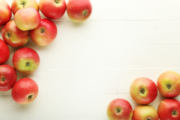Ripe and sweet apples on wooden table
