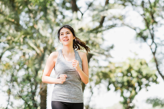 Beautiful Young Healthy Asian Woman Running In The Park