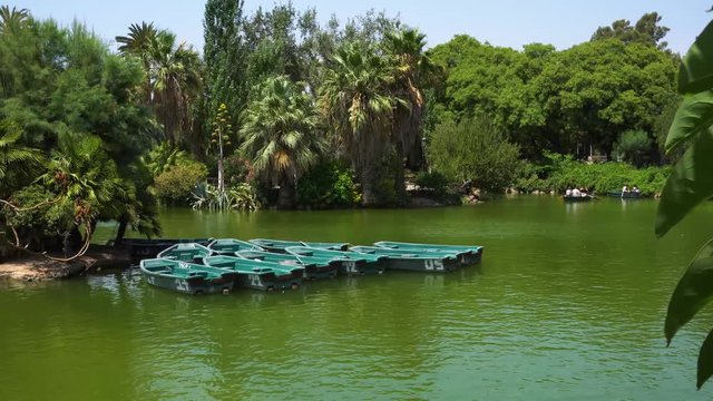 View of Swinging boats on lake at Park de la Ciutadella of Barcelona, Spain