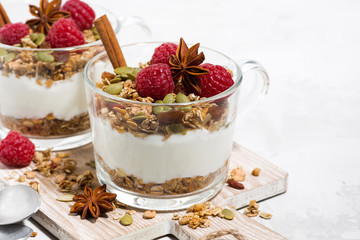 spicy dessert with sweet granola and yogurt on wooden board