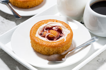 sweet pastry with cream, jam and a cup of coffee