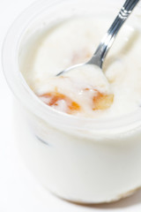 yoghurt in a jar with peach, vertical closeup