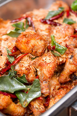 Close Up of Deep Fried Chicken Wing with Thai Herbs