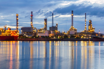 Fototapeta na wymiar Oil refinery plant at twilight with after rain sky background.