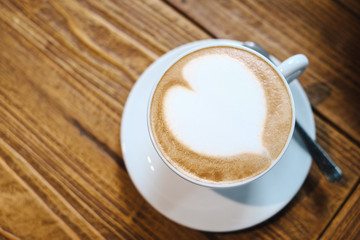 top view heart latte art on wooden table