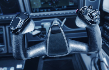 Inside the cockpit of the snall airplane. The steering wheel of the aircraft.