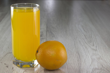 Orange and a glass of juice on the table