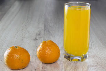 Mandarin and a glass of juice on the table