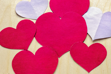 Paper hearts on wooden background. Valentine's Day. Symbol of love.