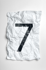 Typewritten numerals on crumpled paper