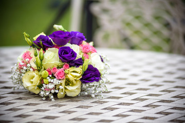 wedding Bridal bouquet with pink and white roses lying on a metal grid table